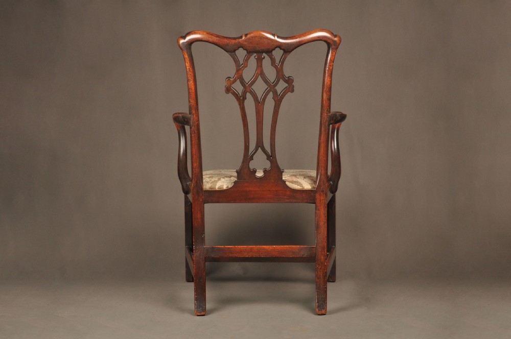 An 18th-century Chippendale mahogany armchair featuring a carved pierced splat back, swept armrests, an upholstered drop-in seat, and square legs joined by H-stretchers. View XII