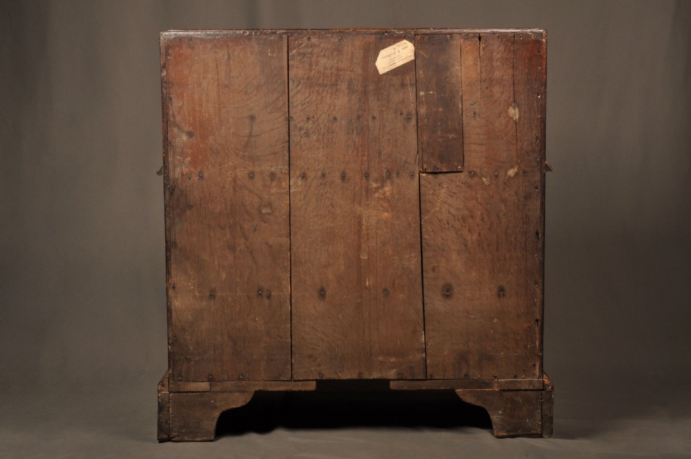 An eighteenth-century Queen Anne burr walnut bureau with a sloping fall-front lid above drawers featuring brass drop handles, resting on bracket feet. View XIII