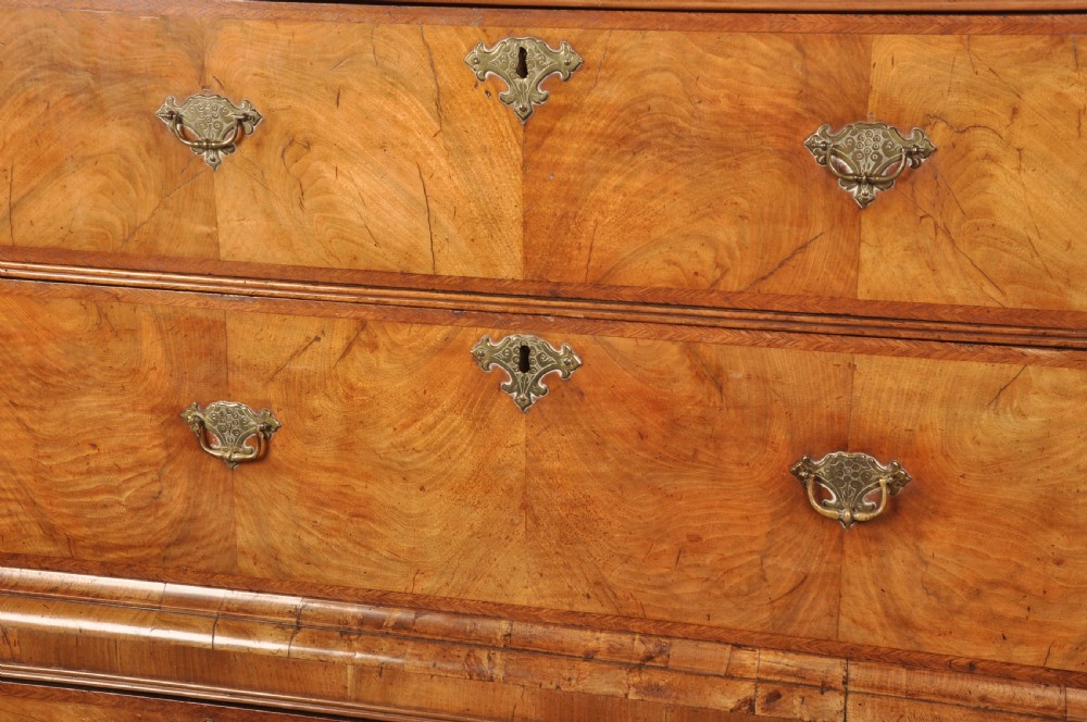 A tall Queen Anne walnut chest on chest featuring two stacked sections of drawers with brass handles and bracket feet. View X