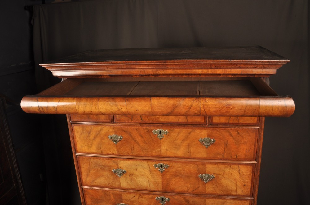 A tall Queen Anne walnut chest on chest featuring two stacked sections of drawers with brass handles and bracket feet. View XI