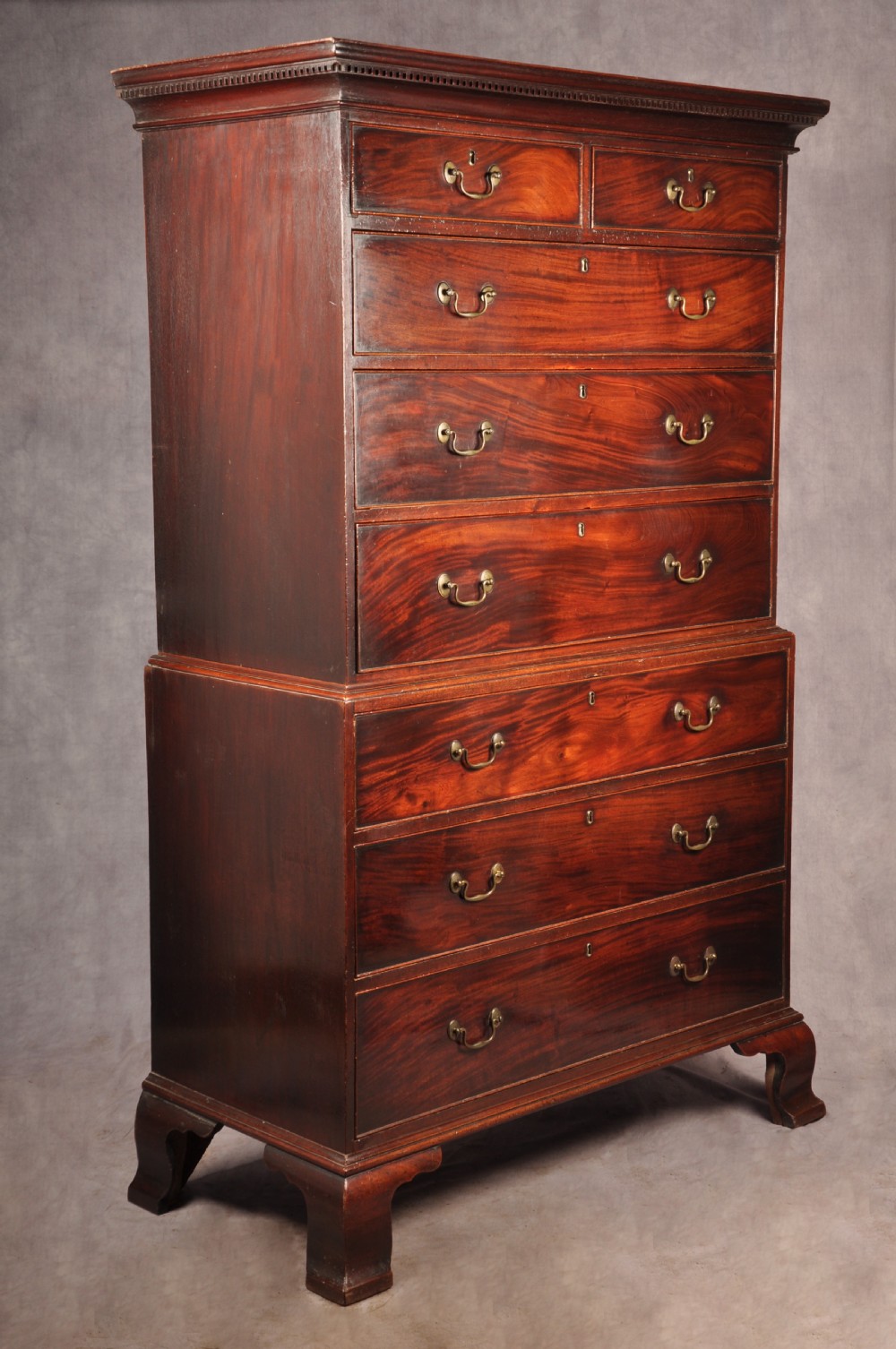 An 18th-century Georgian mahogany chest-on-chest featuring a two-part construction with brass swan-neck handles and bracket feet. View II