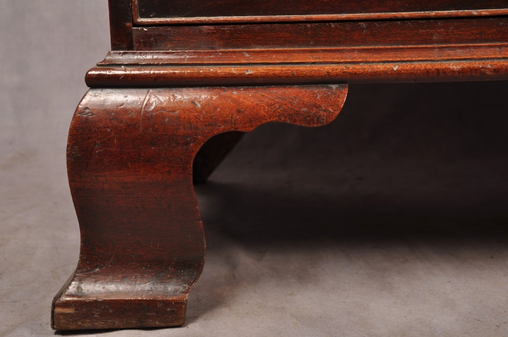 An 18th-century Georgian mahogany chest-on-chest featuring a two-part construction with brass swan-neck handles and bracket feet. View V
