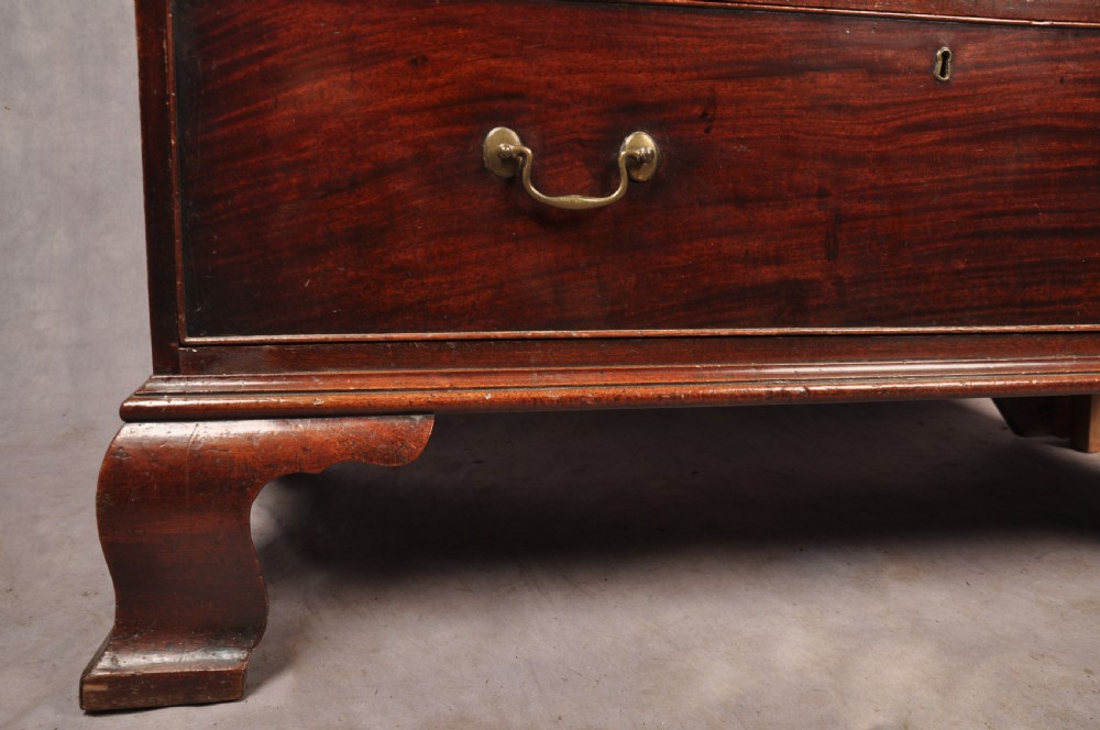 An 18th-century Georgian mahogany chest-on-chest featuring a two-part construction with brass swan-neck handles and bracket feet. View VI