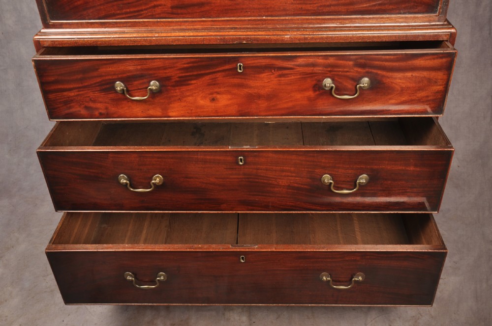 An 18th-century Georgian mahogany chest-on-chest featuring a two-part construction with brass swan-neck handles and bracket feet. View VII