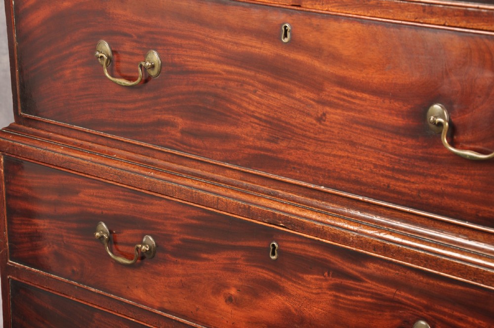 An 18th-century Georgian mahogany chest-on-chest featuring a two-part construction with brass swan-neck handles and bracket feet. View XII
