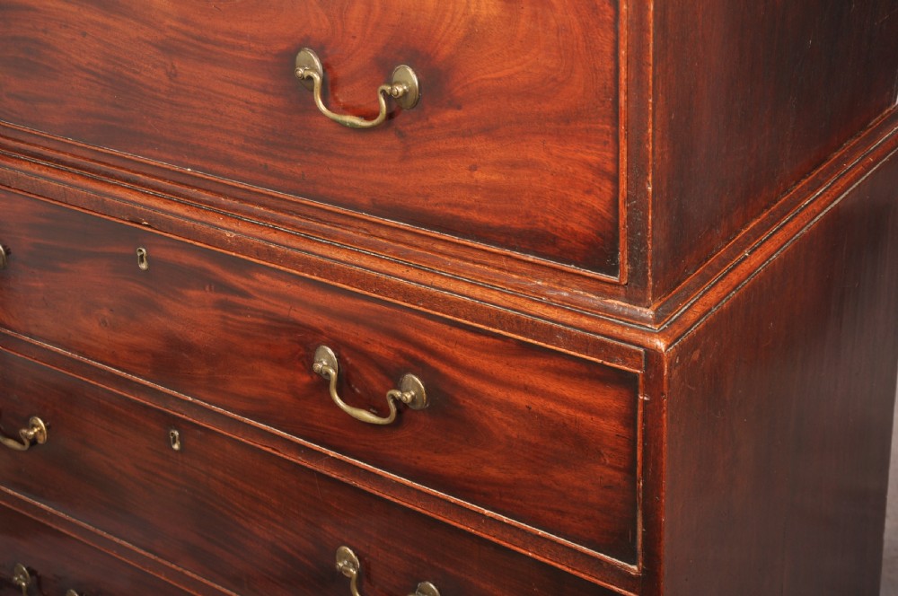 An 18th-century Georgian mahogany chest-on-chest featuring a two-part construction with brass swan-neck handles and bracket feet. View XIII