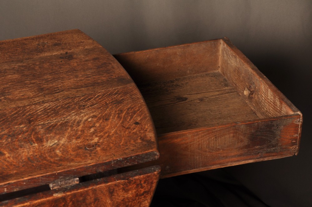 A large 17th-century solid oak gateleg dining table featuring drop leaves, turned legs, and perimeter stretchers. View IV