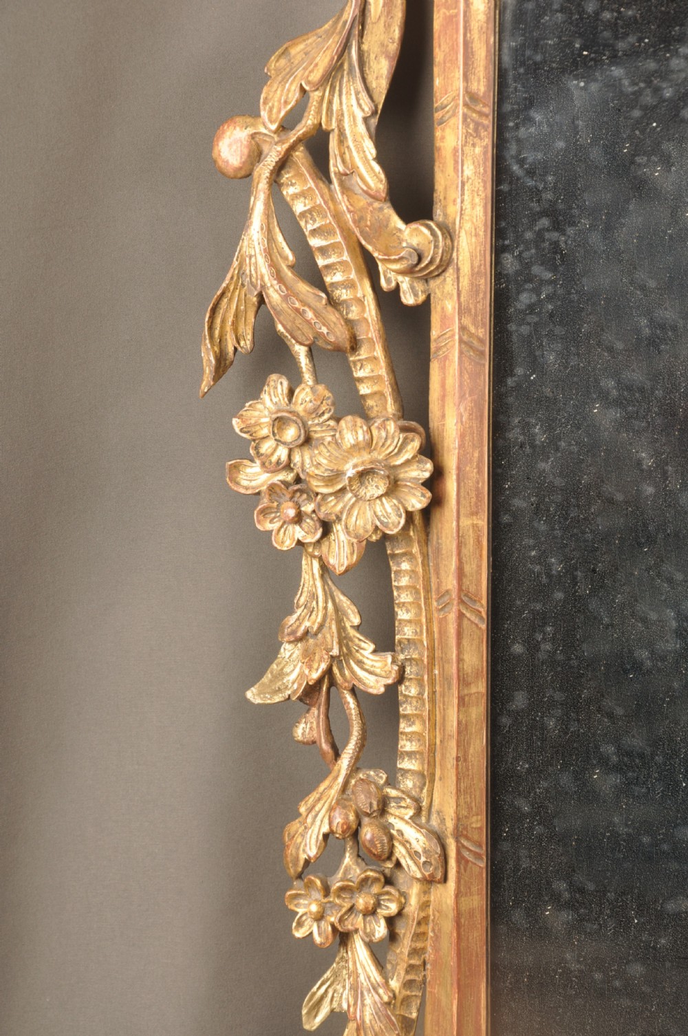 An 18th-century horizontal giltwood overmantel mirror featuring three glass plates set within a carved frame decorated with acanthus scrolls, C-scrolls, and floral motifs. View VI