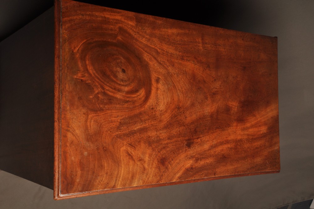 An 18th-century mahogany kneehole desk featuring a long upper drawer, six smaller side drawers, a central recessed cupboard, and bracket feet. View XII