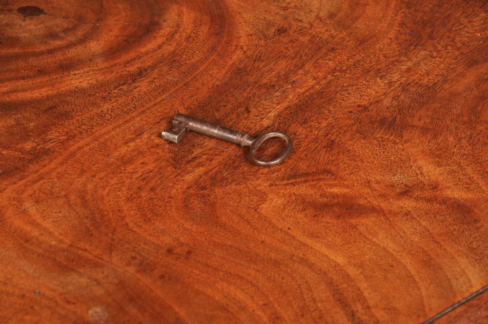 An 18th-century mahogany kneehole desk featuring a long upper drawer, six smaller side drawers, a central recessed cupboard, and bracket feet. View XIII