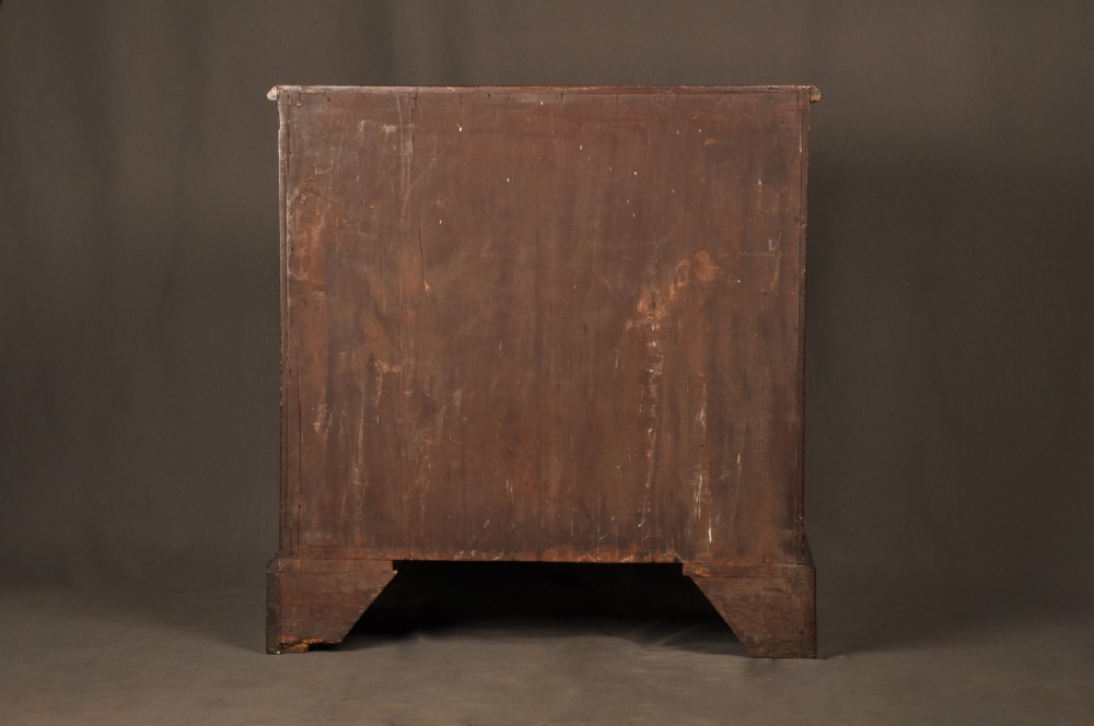 An 18th-century mahogany kneehole desk featuring a long upper drawer, six smaller side drawers, a central recessed cupboard, and bracket feet. View XVII