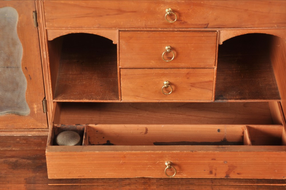 An 18th-century mahogany secretaire bookcase featuring a dentil cornice, astragal-glazed upper cabinet doors, a drop-front writing drawer with brass handles, and a two-door lower cupboard resting on bracket feet. View VI