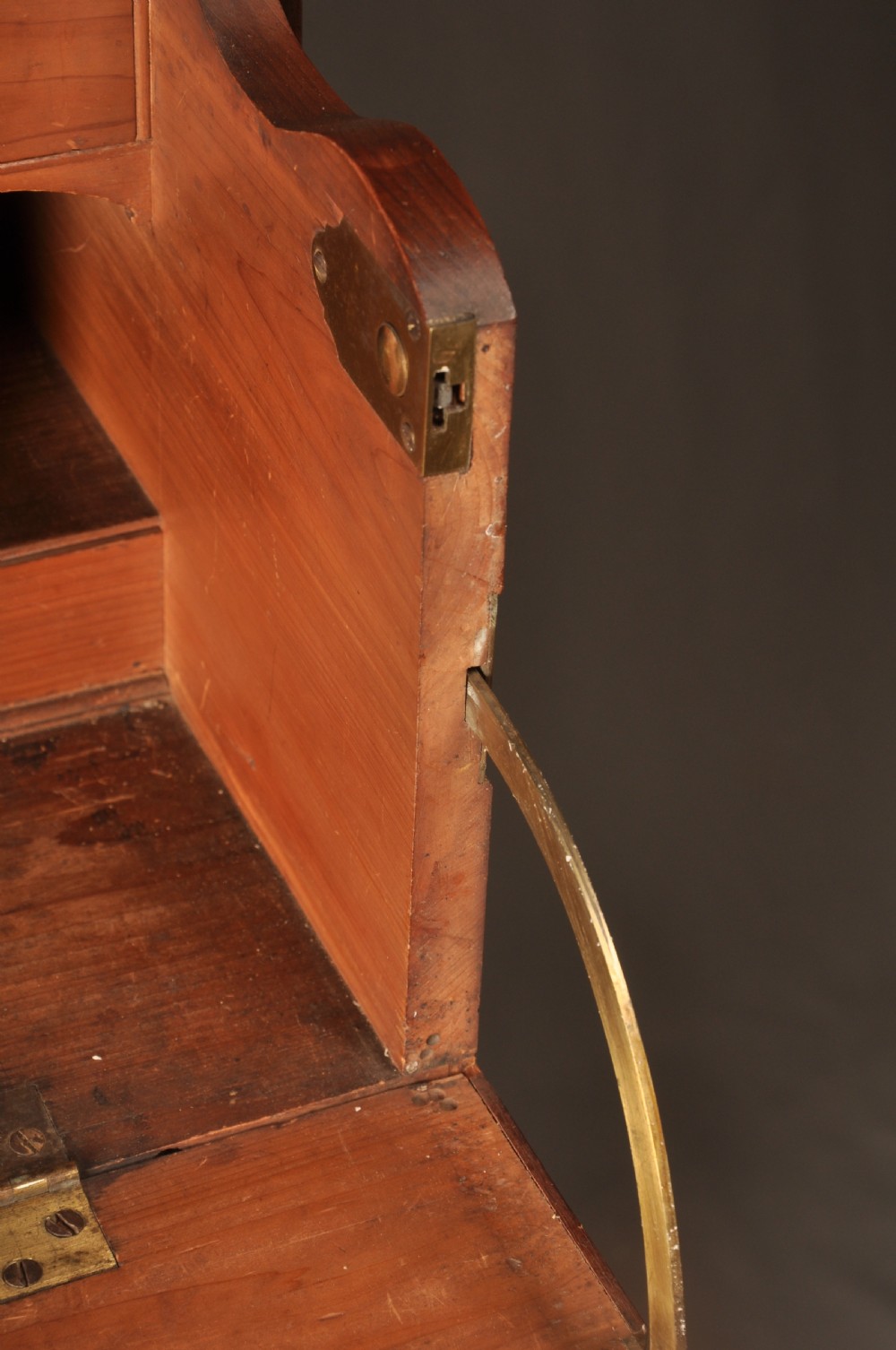 An 18th-century mahogany secretaire bookcase featuring a dentil cornice, astragal-glazed upper cabinet doors, a drop-front writing drawer with brass handles, and a two-door lower cupboard resting on bracket feet. View VII
