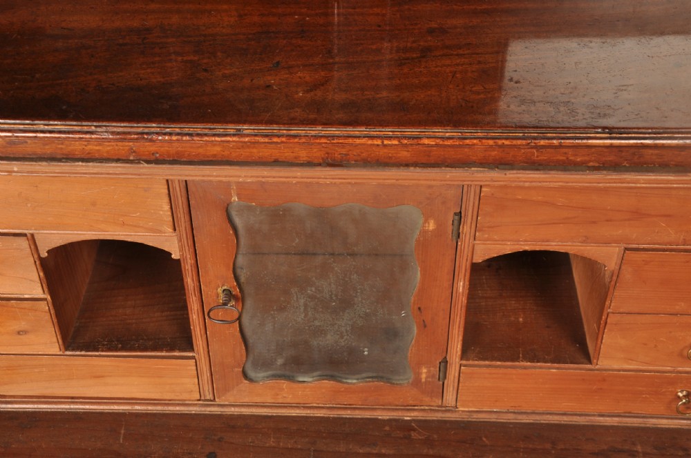 An 18th-century mahogany secretaire bookcase featuring a dentil cornice, astragal-glazed upper cabinet doors, a drop-front writing drawer with brass handles, and a two-door lower cupboard resting on bracket feet. View XII