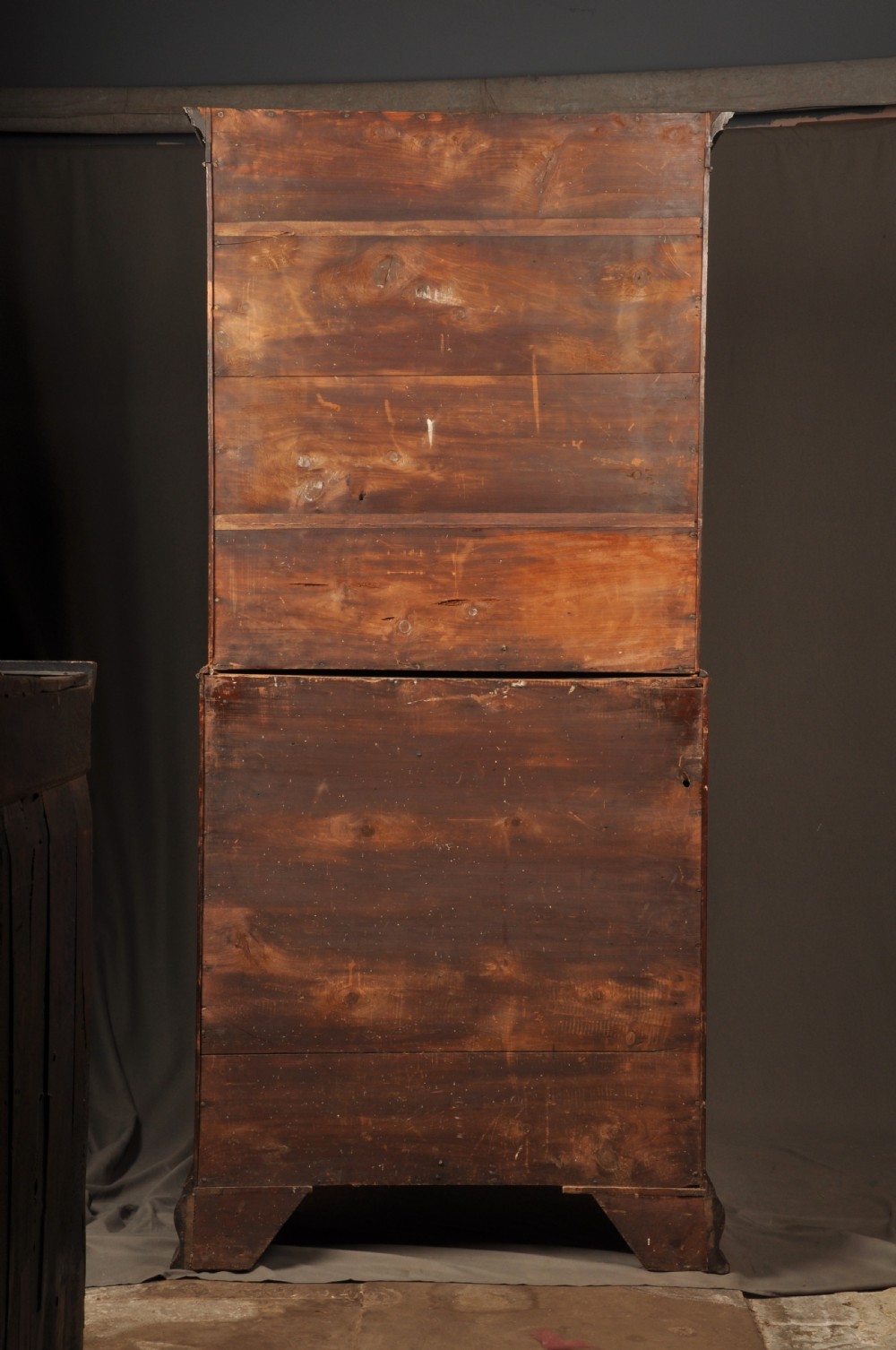 An 18th-century mahogany secretaire bookcase featuring a dentil cornice, astragal-glazed upper cabinet doors, a drop-front writing drawer with brass handles, and a two-door lower cupboard resting on bracket feet. View XVII