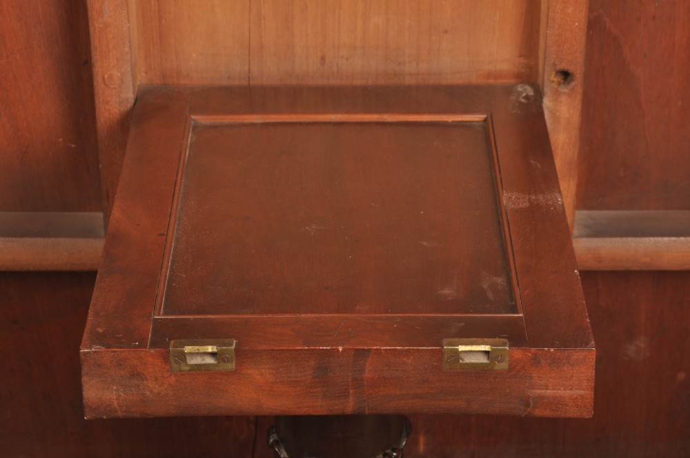 A Regency mahogany breakfast table featuring a rounded rectangular top, a turned central pedestal with acanthus carving, and four splayed legs with brass paw feet. View XII