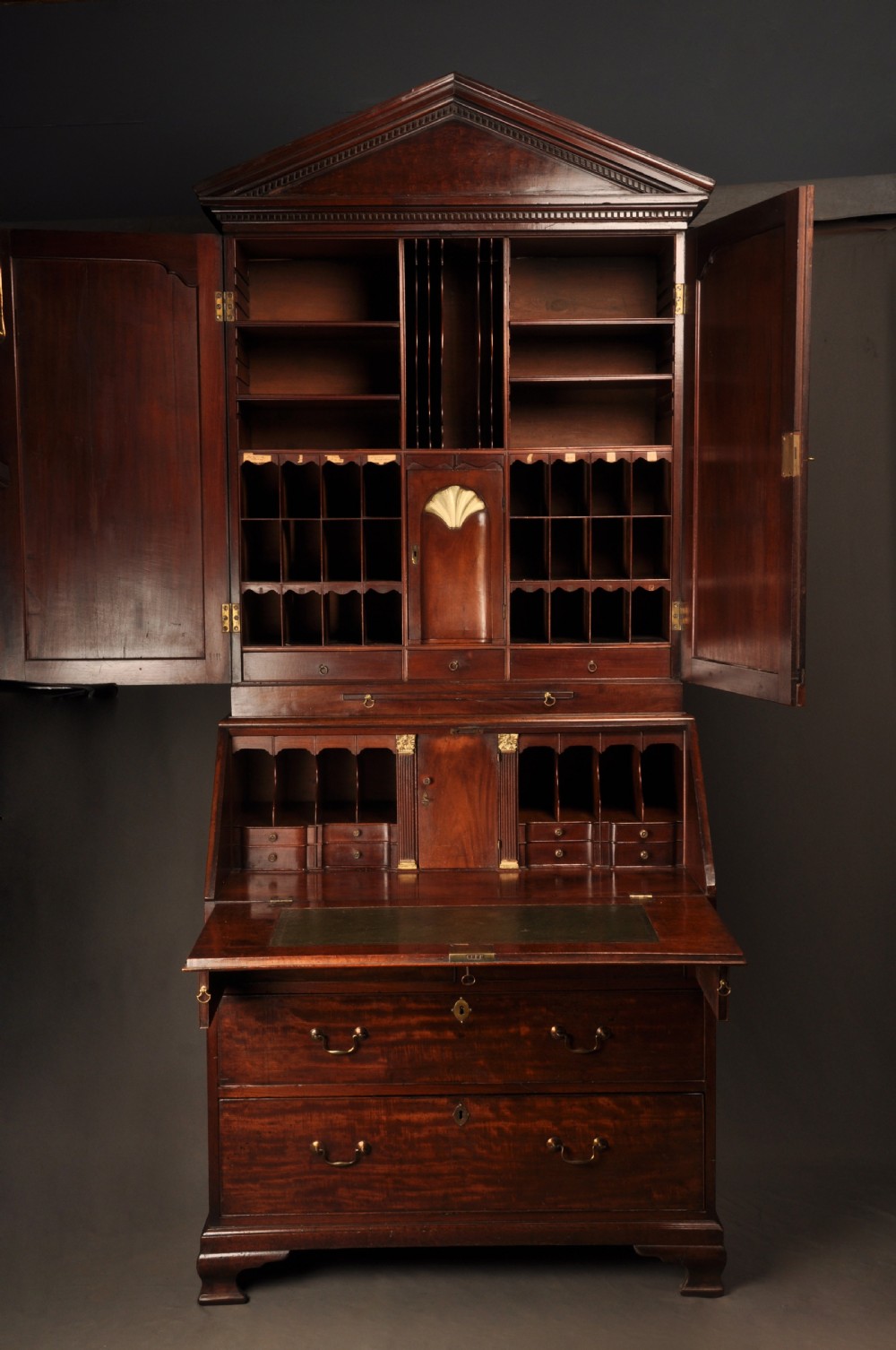An 18th-century mahogany bureau cabinet featuring an architectural pediment top, two panelled upper doors, a slant-front writing desk, and lower drawers on bracket feet. View III