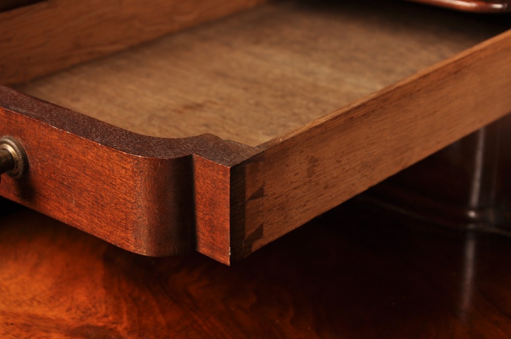 An 18th-century mahogany bureau cabinet featuring an architectural pediment top, two panelled upper doors, a slant-front writing desk, and lower drawers on bracket feet. View IX