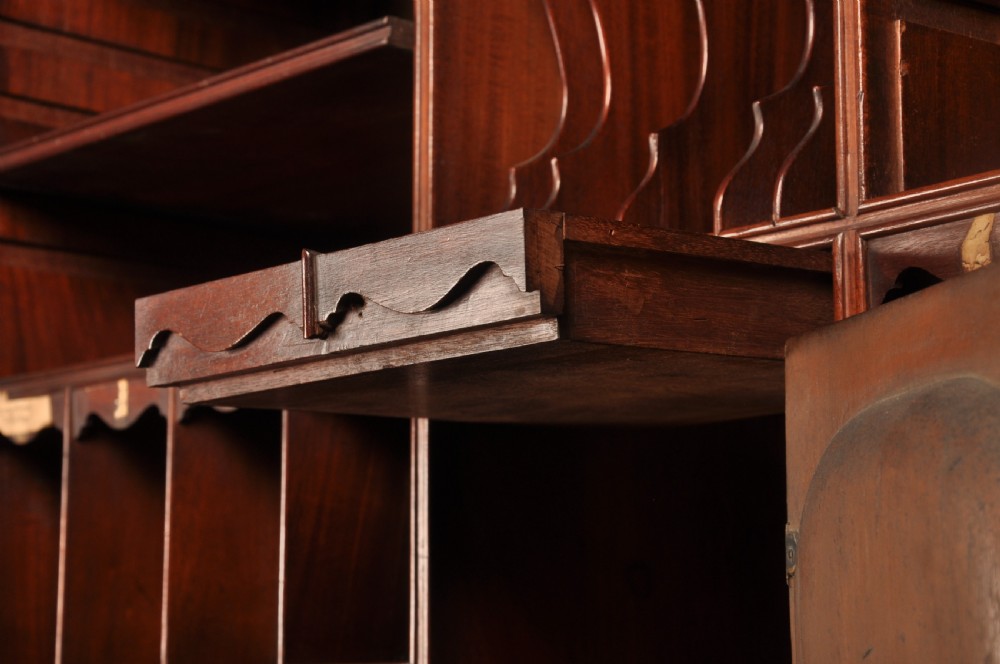 An 18th-century mahogany bureau cabinet featuring an architectural pediment top, two panelled upper doors, a slant-front writing desk, and lower drawers on bracket feet. View XIII