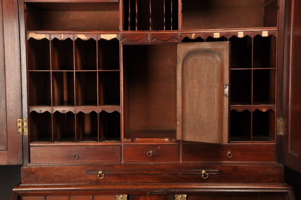 An 18th-century mahogany bureau cabinet featuring an architectural pediment top, two panelled upper doors, a slant-front writing desk, and lower drawers on bracket feet. View XIV