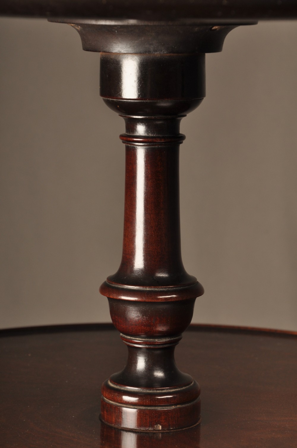 An 18th-century mahogany three-tiered dumb waiter featuring graduated dished trays, a turned central column, and tripod cabriole legs. View IV