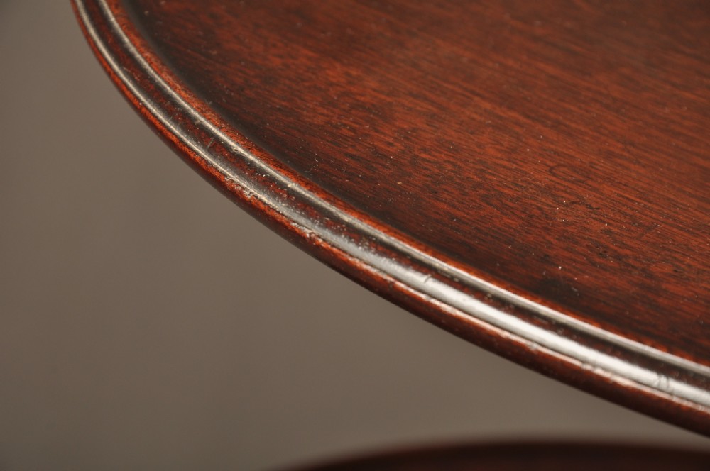 An 18th-century mahogany three-tiered dumb waiter featuring graduated dished trays, a turned central column, and tripod cabriole legs. View VI