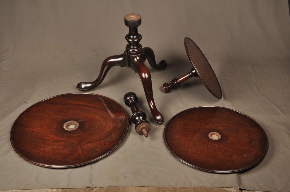 An 18th-century mahogany three-tiered dumb waiter featuring graduated dished trays, a turned central column, and tripod cabriole legs. View VIII