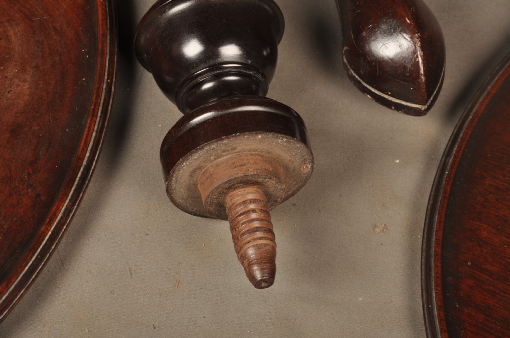 An 18th-century mahogany three-tiered dumb waiter featuring graduated dished trays, a turned central column, and tripod cabriole legs. View X
