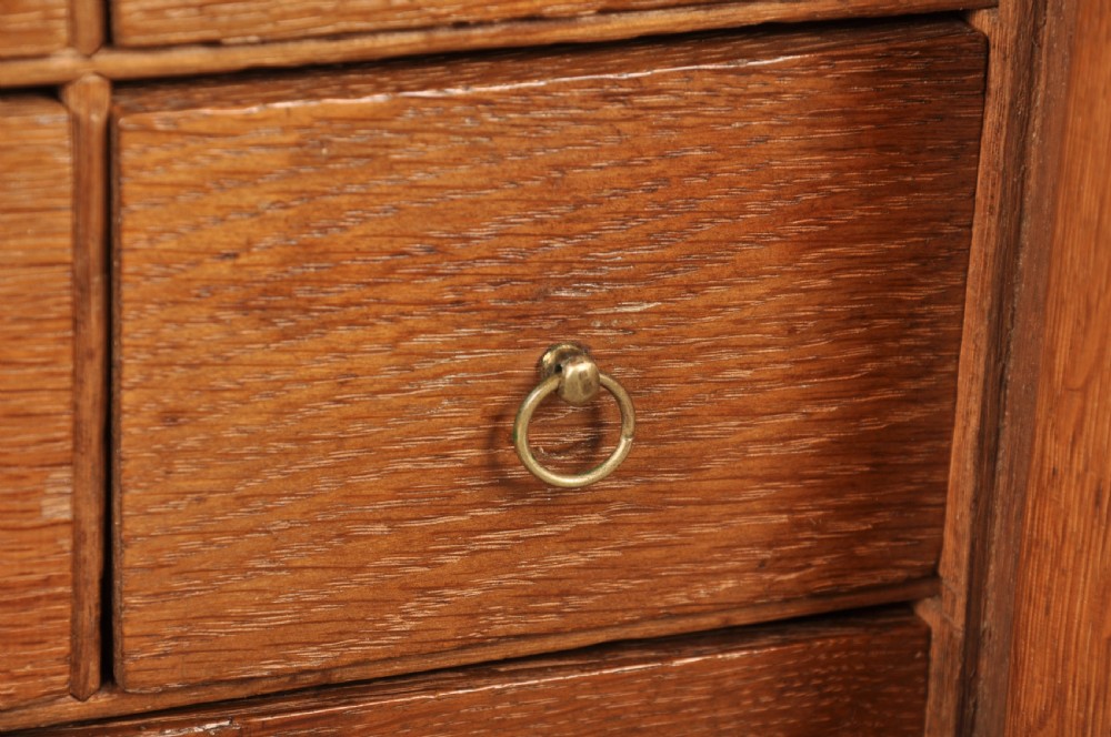 A mid-18th-century oak spice cupboard featuring a single fielded panel door with a brass keyhole escutcheon and a moulded base. View VIII