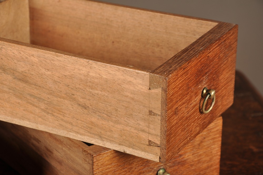A mid-18th-century oak spice cupboard featuring a single fielded panel door with a brass keyhole escutcheon and a moulded base. View IX