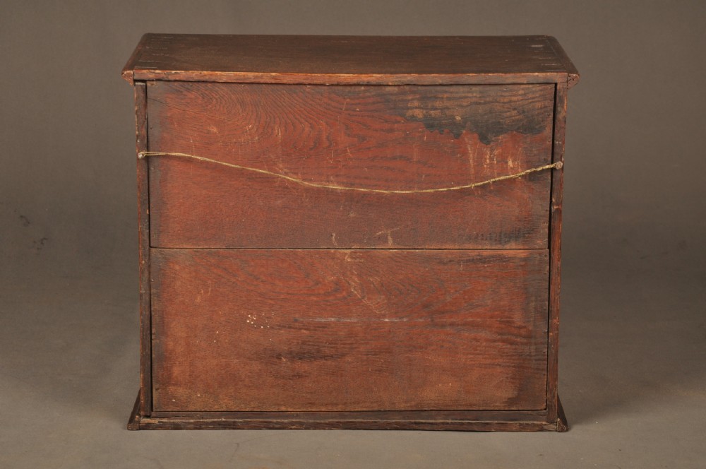 A mid-18th-century oak spice cupboard featuring a single fielded panel door with a brass keyhole escutcheon and a moulded base. View XII