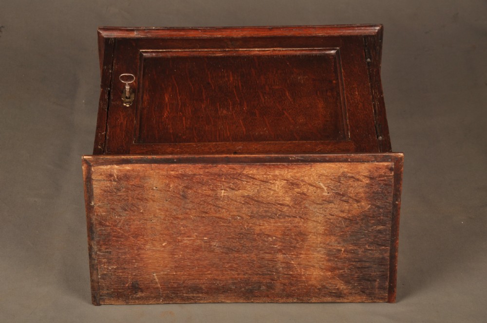 A mid-18th-century oak spice cupboard featuring a single fielded panel door with a brass keyhole escutcheon and a moulded base. View XIII