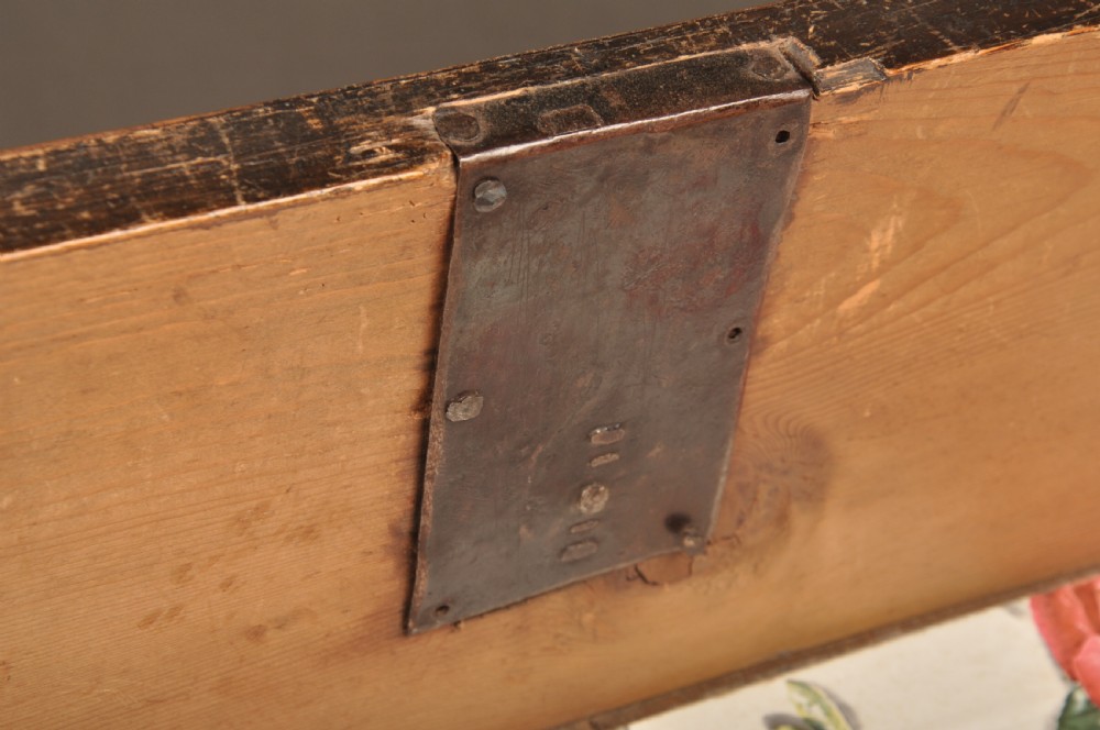A seventeenth-century olive oyster veneered chest of drawers featuring two short drawers above three long drawers, brass drop handles, and turned bun feet. View VIII