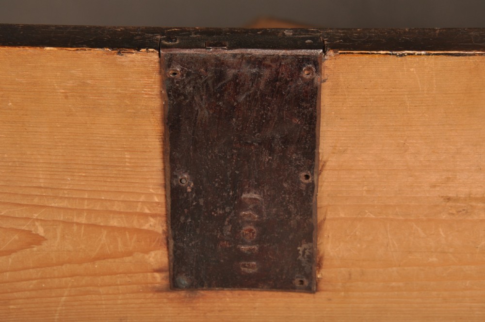 A seventeenth-century olive oyster veneered chest of drawers featuring two short drawers above three long drawers, brass drop handles, and turned bun feet. View IX