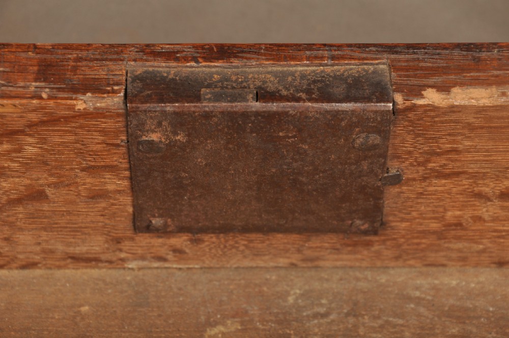 A mid-18th-century warm brown oak slant-front writing bureau featuring four graduated drawers with brass swan-neck handles and bracket feet. View VII