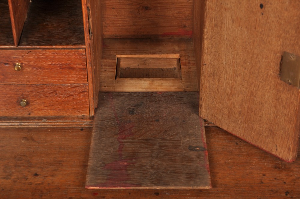 A mid-18th-century warm brown oak slant-front writing bureau featuring four graduated drawers with brass swan-neck handles and bracket feet. View XV