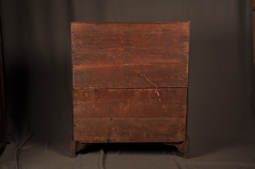 A mid-18th-century warm brown oak slant-front writing bureau featuring four graduated drawers with brass swan-neck handles and bracket feet. View XIX