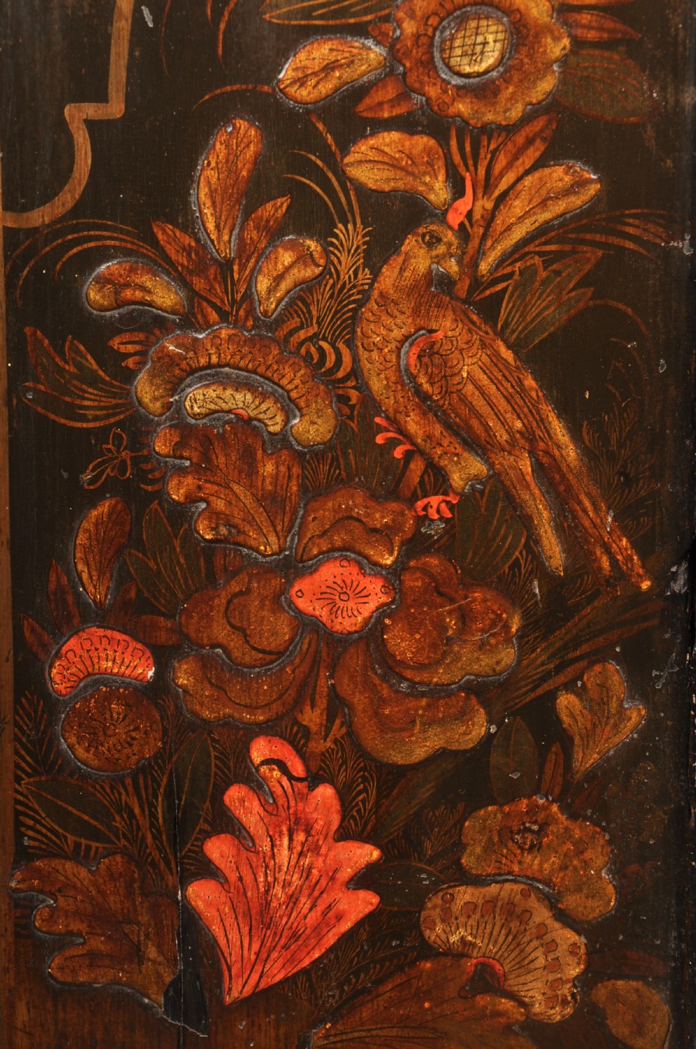 An early 18th-century black japanned hanging corner cupboard featuring hand-painted chinoiserie decoration depicting birds, flora, and architectural structures with brass butterfly hinges. View II
