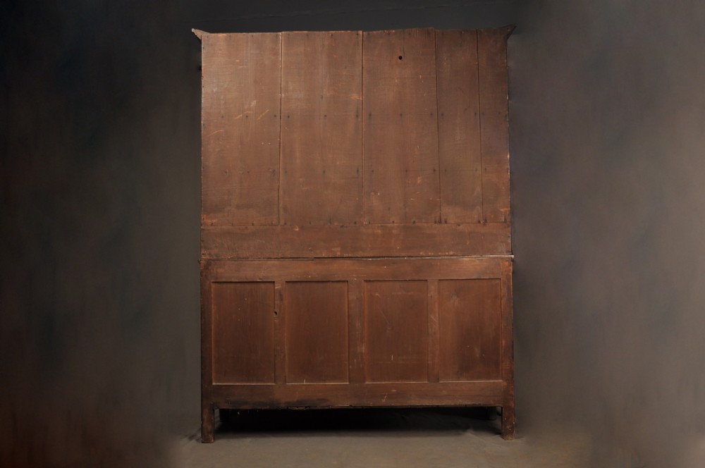 An eighteenth-century warm brown oak dresser featuring an upper three-tier open plate rack above a lower cabinet with drawers and panelled cupboard doors. View XVII