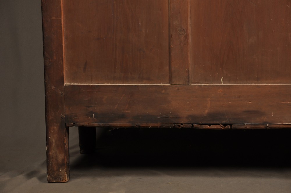 An eighteenth-century warm brown oak dresser featuring an upper three-tier open plate rack above a lower cabinet with drawers and panelled cupboard doors. View XVIII