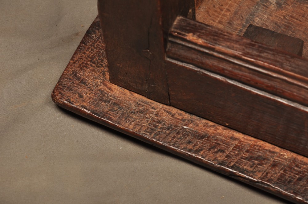 An 18th-century oak joint stool featuring baluster turned legs, plain stretchers, a rectangular moulded top, and dark brown patinated wood. View XIII