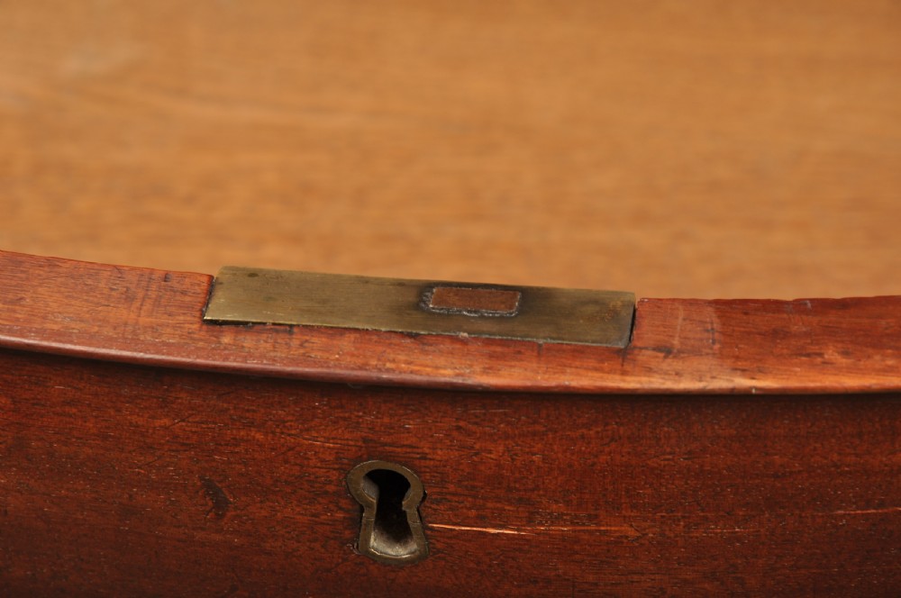 An 18th-century Georgian mahogany serpentine chest of drawers featuring four graduated drawers, brass swan-neck handles, and bracket feet. View IX
