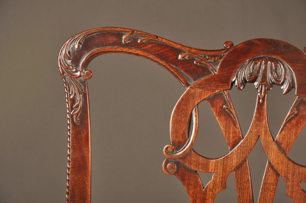 An 18th-century Georgian Chippendale mahogany armchair featuring a carved pierced splat back, shaped arms, and a floral needlepoint drop-in seat. View V