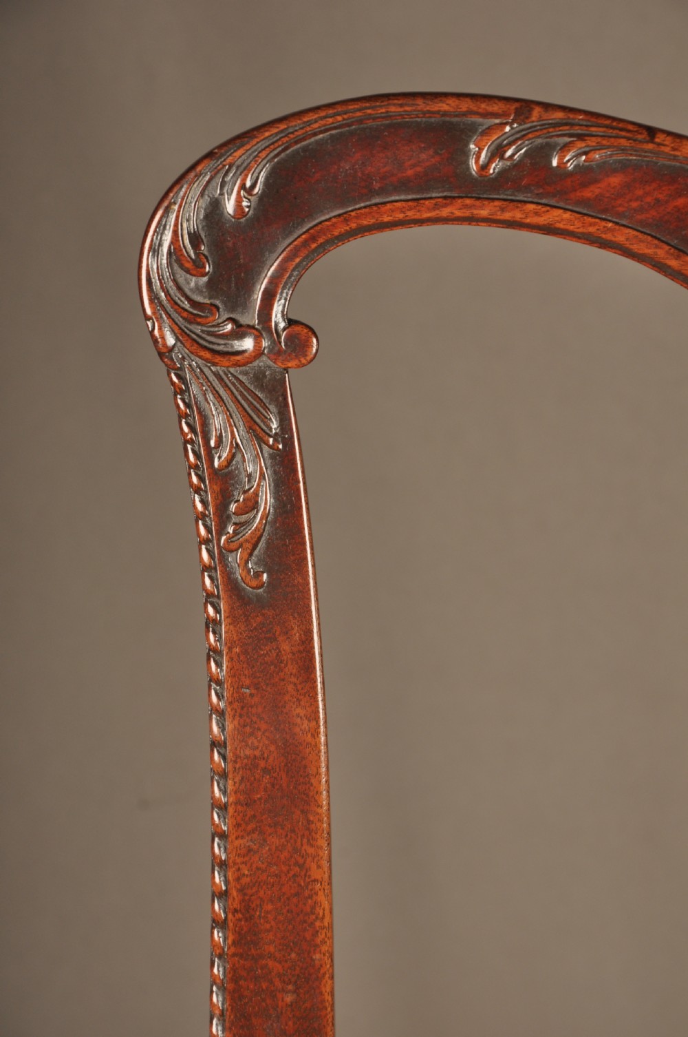 An 18th-century Georgian Chippendale mahogany armchair featuring a carved pierced splat back, shaped arms, and a floral needlepoint drop-in seat. View XI