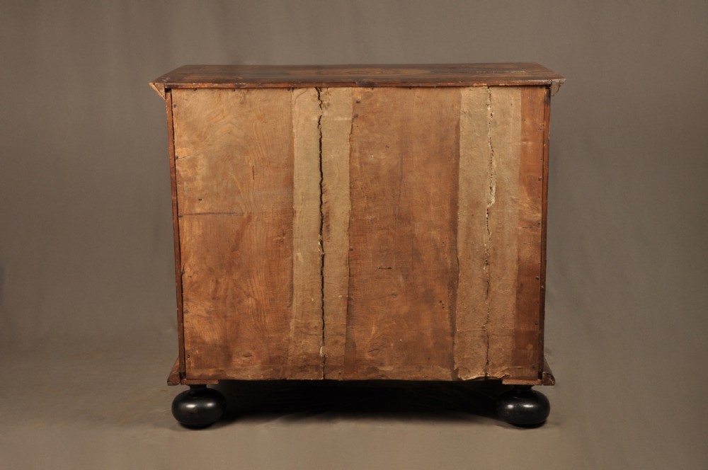 A late 17th-century walnut chest of drawers featuring arabesque marquetry inlays, tear-drop brass handles, and ebonised bun feet. View XV