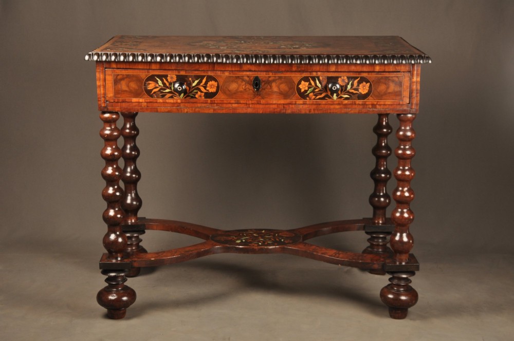An antique brown walnut centre table featuring detailed floral marquetry inlays across the tabletop, single drawer front, and stretcher base, supported by bobbin-turned legs. View II