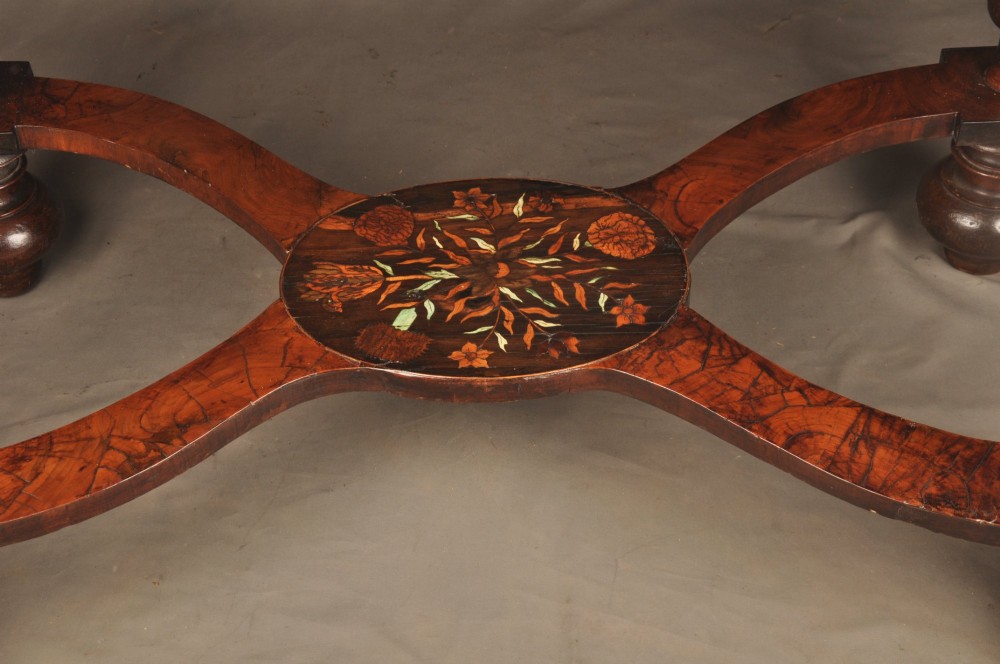 An antique brown walnut centre table featuring detailed floral marquetry inlays across the tabletop, single drawer front, and stretcher base, supported by bobbin-turned legs. View XI