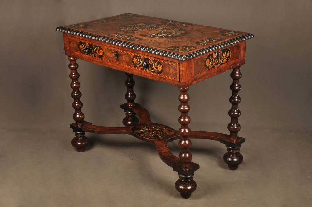 An antique brown walnut centre table featuring detailed floral marquetry inlays across the tabletop, single drawer front, and stretcher base, supported by bobbin-turned legs. View XIII