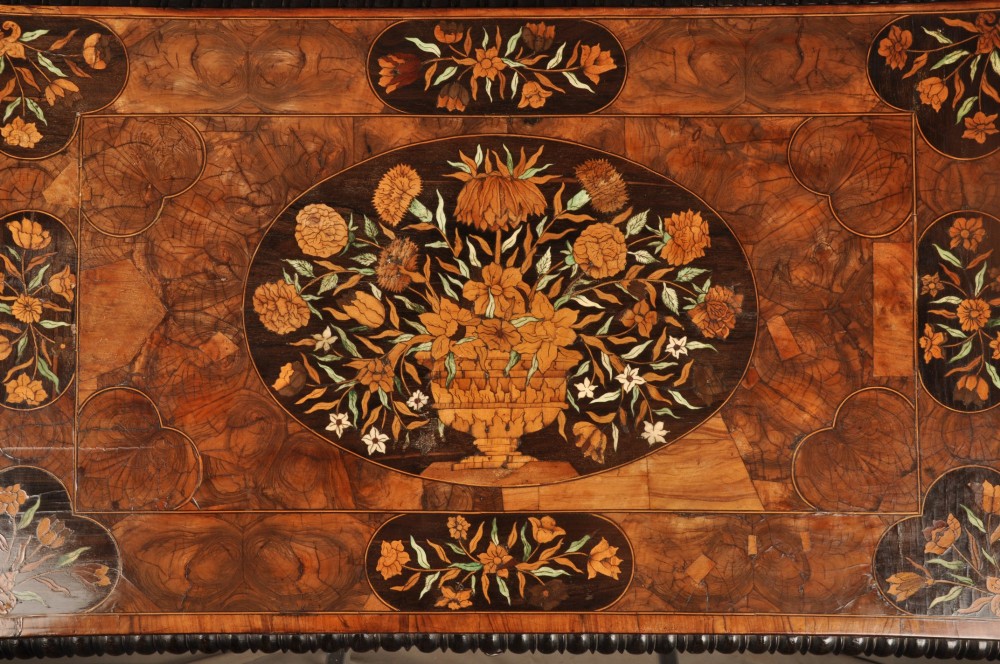 An antique brown walnut centre table featuring detailed floral marquetry inlays across the tabletop, single drawer front, and stretcher base, supported by bobbin-turned legs. View XV