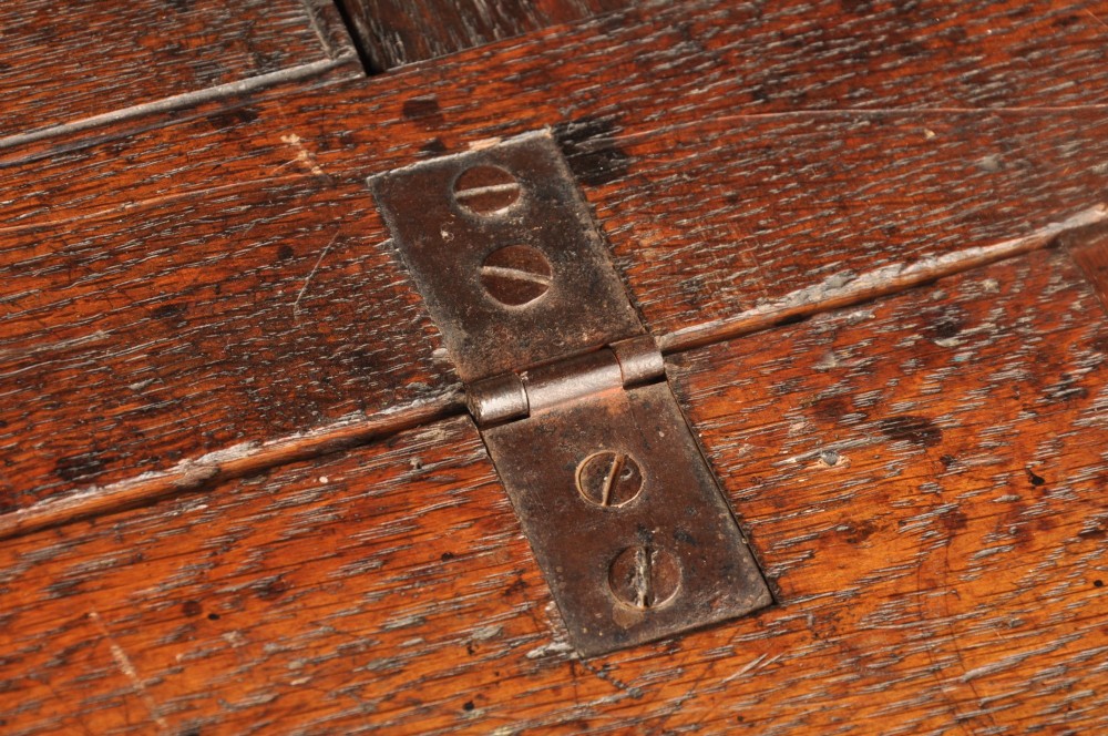 An early 18th-century oak bureau featuring a slant-front writing flap above two short and two long drawers with brass hardware. View VIII
